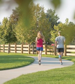 Couple Running on Community Trail