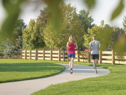 Couple running on community trail